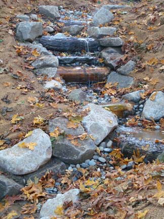 Stream flowing below rock feature